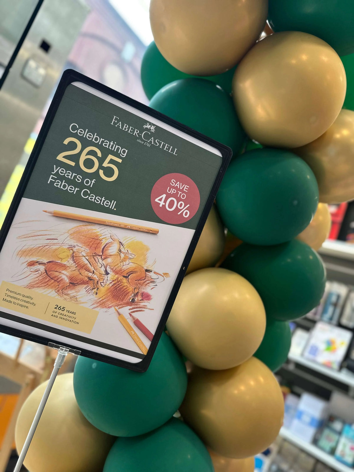 Celebrating 265 Years of Faber-Castell promotional display with balloons and savings announcement.