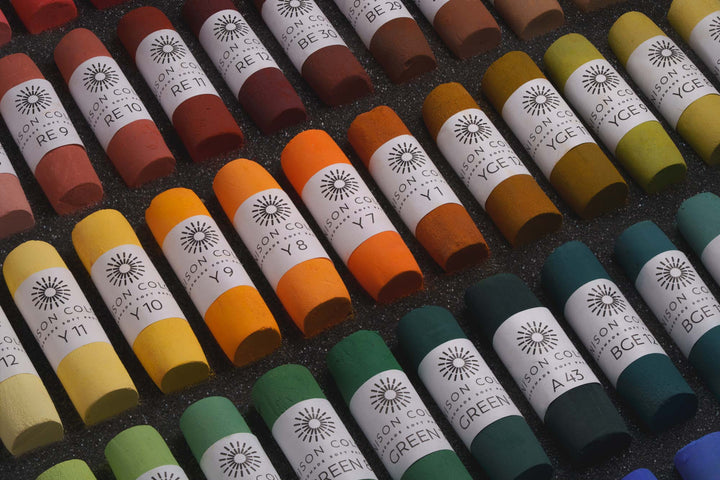Unison Colour soft pastels laid out in rows