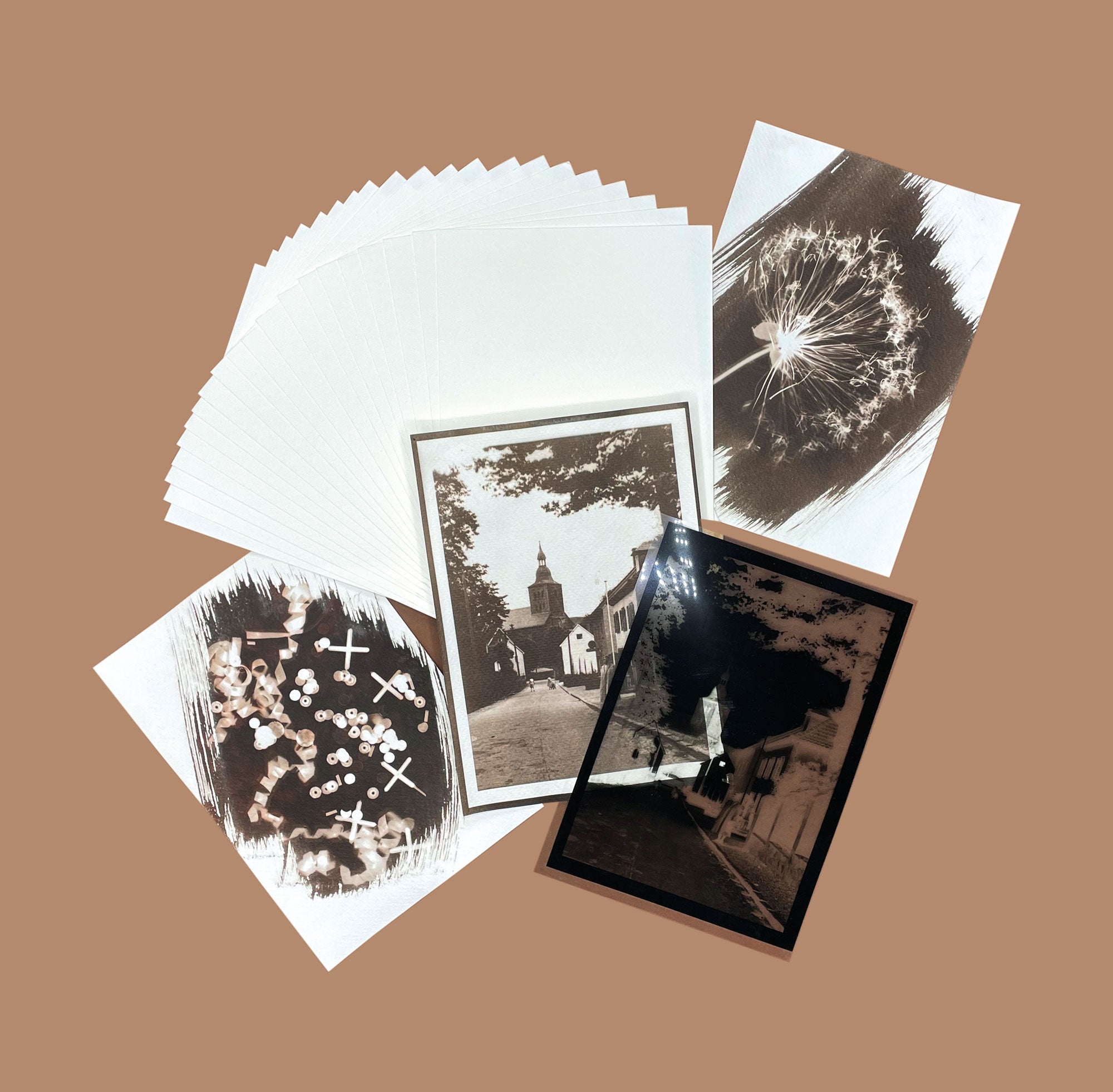 Sepia Van Dyke prints with stack of cold-pressed watercolour paper