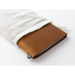 TRAVELER'S notebook Camel Regular Size in use, showing the leather ageing with handling