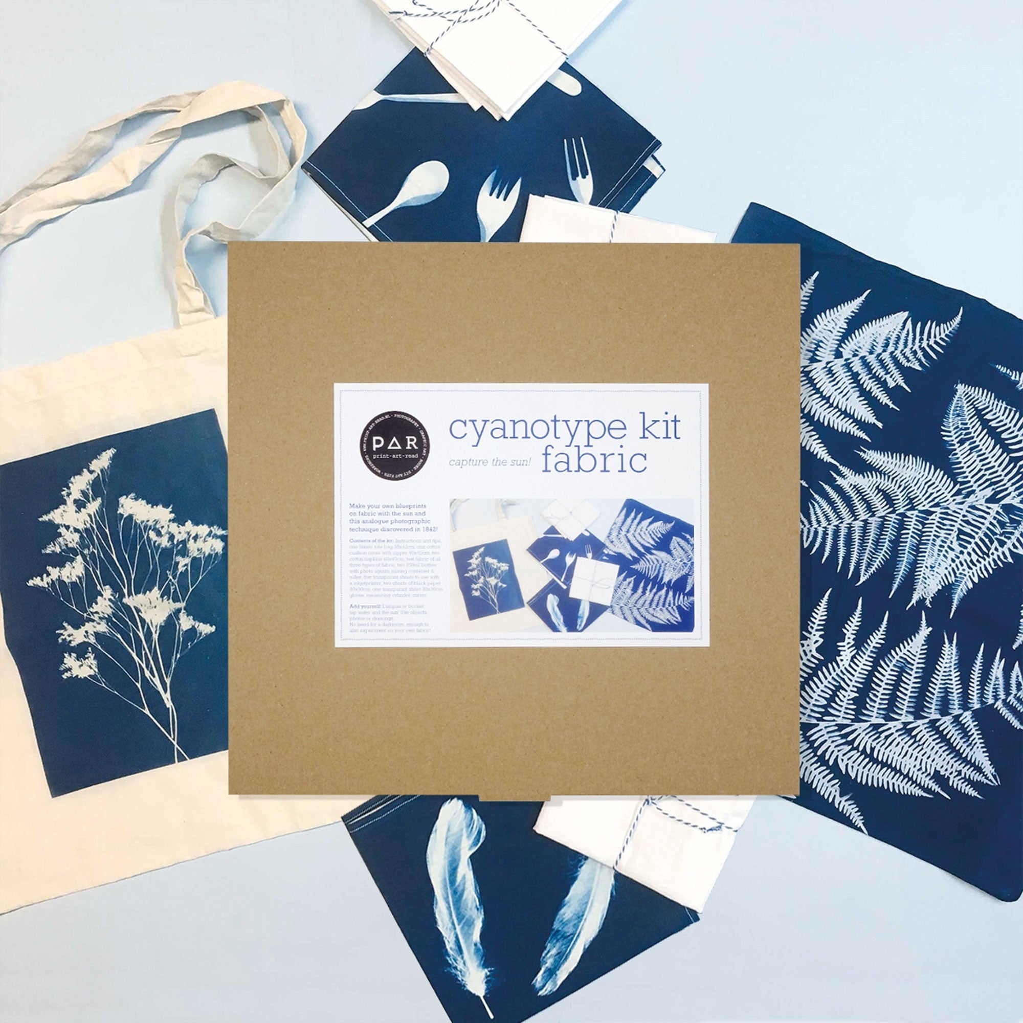PAR Cyanotype Fabric Kit box with Prussian blue botanical sun prints on fabric and tote bag