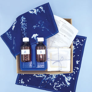 Contents of the cyanotype fabric kit – sensitiser bottles, fabric and instructions in box