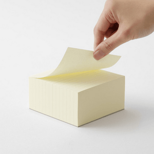 Hand picking sheet from MD Block Memo Pad Lined, 500 sheets, 100x100x51mm, 409g, Japanese paper