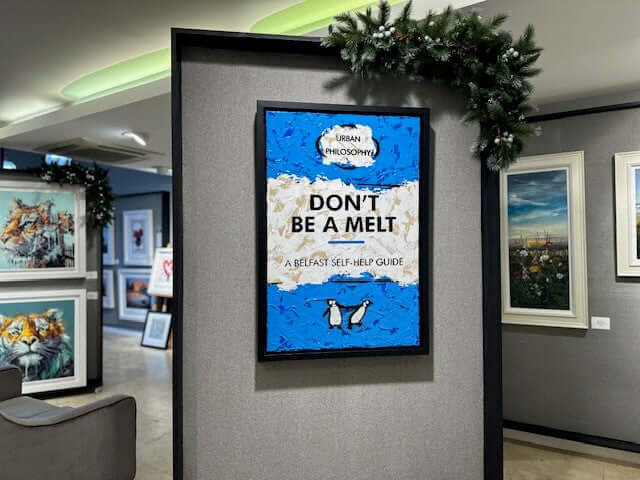 Framed 'Don't Be A Melt - Original by Hue Folk' artwork in gallery setting, featuring bold typography and vibrant colors.