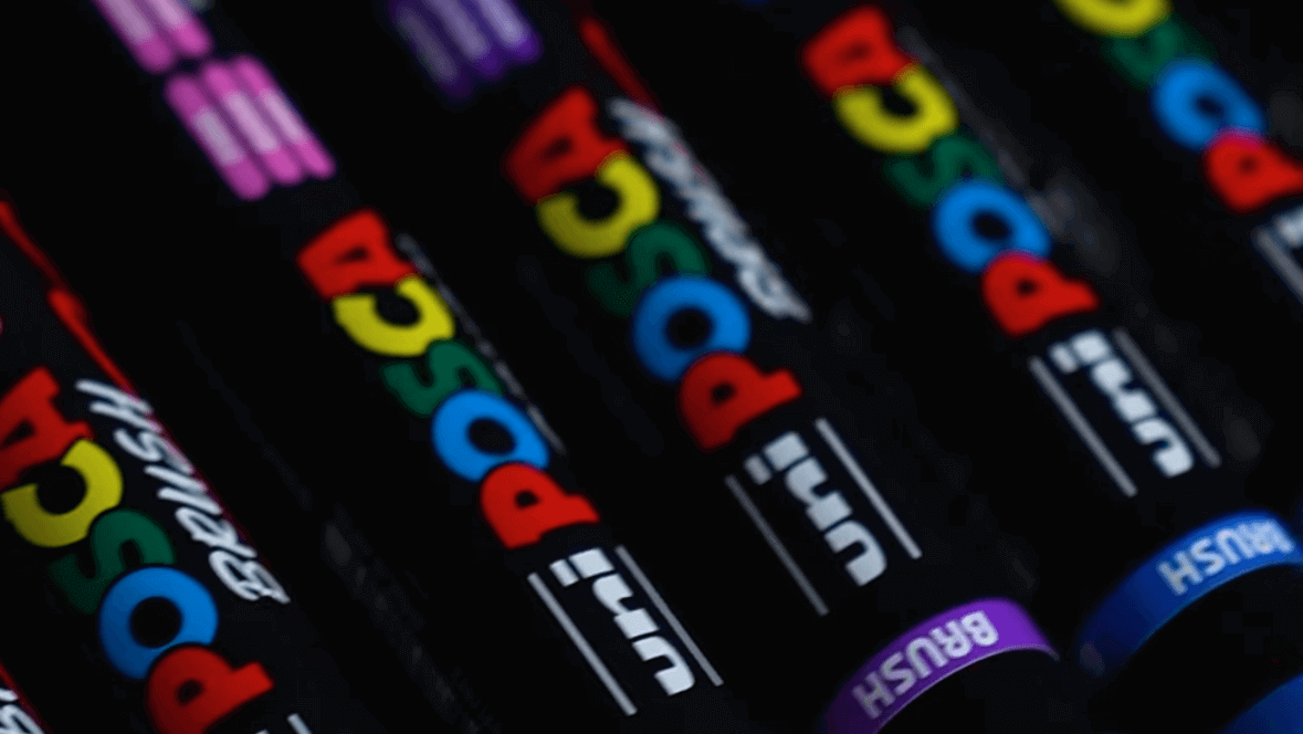 Close-up of POSCA Brush PC-5BR paint pens in various colors, ideal for fine details or bold strokes on multiple surfaces.