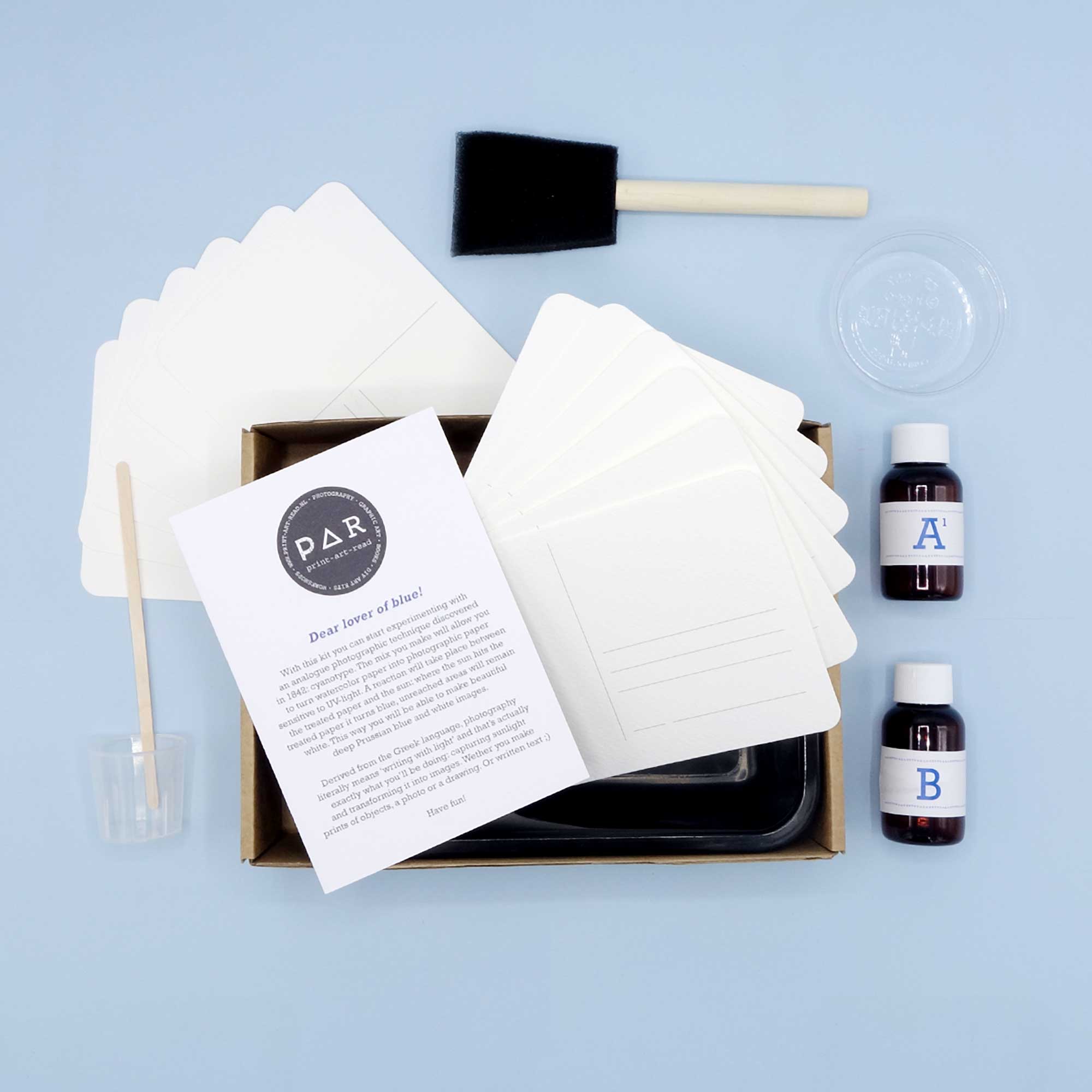 Cyanotype postcard kit contents in box tray with watercolour postcards and sensitiser