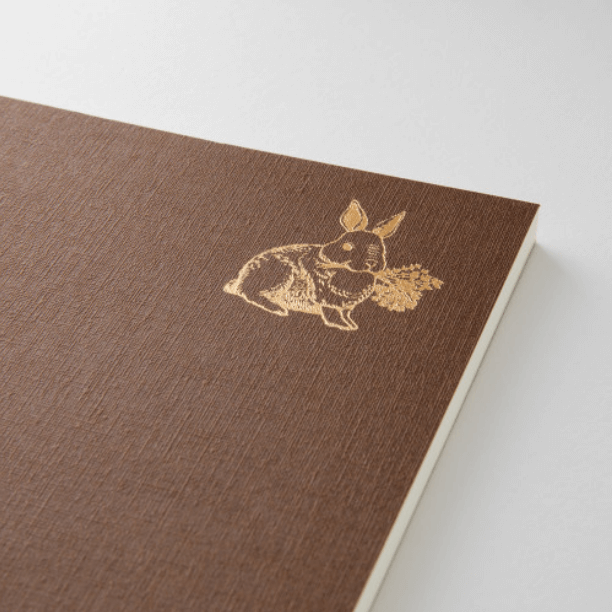 Midori Diary – Yummy | Food Memory Journal (116 Pages) with brown cloth cover and gold-foil rabbit illustration.