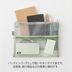 Midori Pen & Tool Pouch B5 – Mesh Green filled with stationery items, showing see-through design and zip closure.