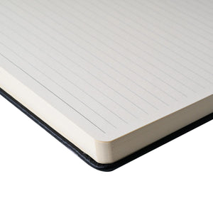 Close-up of the Sakura ruled hard cover notebook with cream white paper and 7 mm ruled lines, featuring a cinder-coloured cover.