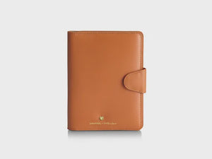 Sheaffer Emily in Paris Full-Grain Leather Passport Case with Pen Loop - Orange on display.