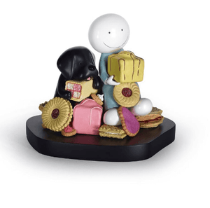 Sweet Talk Sculpture by Doug Hyde featuring a playful character and a black Labrador with British treats like Jammie Dodgers and Battenberg.