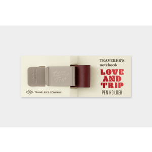 TRAVELER’S notebook Pen Holder – LOVE AND TRIP Red with engraved metal clip and red leather holder on packaging.