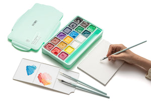 HIMI Jelly Cup Gouache Set - 18 Colours + 3 Brushes (Green Case) shown in use.