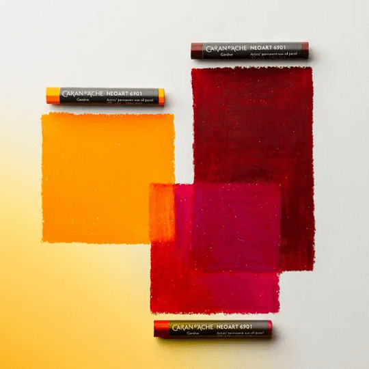 Caran d'Ache Neoart 6901 oil pastels with vibrant yellow, red, and pink color swatches.