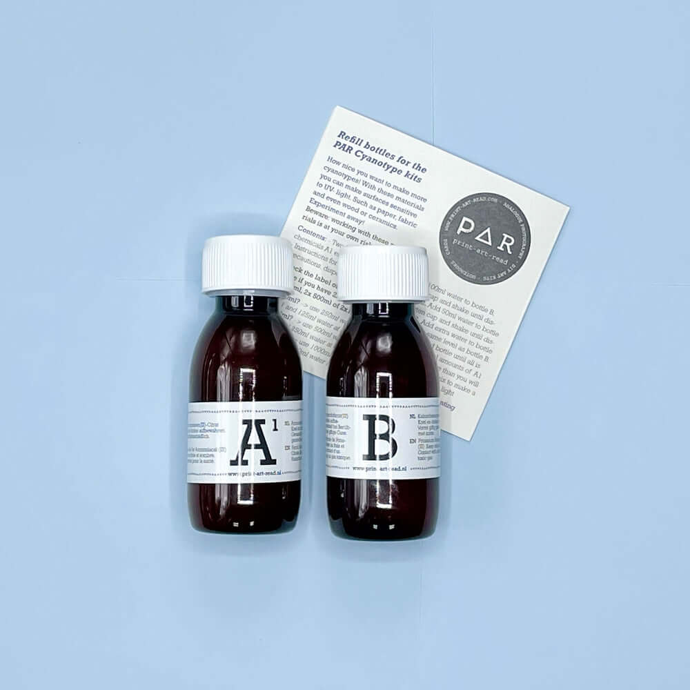 Cyanotype Refill Set – 2x 250ml Sensitiser Bottles (A + B) with instruction leaflet on blue background