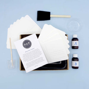 Cyanotype Postcard Kit – DIY Sun‑Print Blueprint Kit for Artists & Creatives with postcards, brush, and sensitiser bottles included.