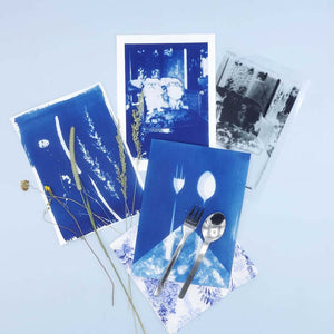 Cyanotype Refill Set – 2×1000 ml Sensitiser Bottles for Sun‑Print Printing on display with artistic sun-prints and utensils.
