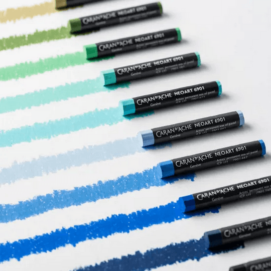 Caran d'Ache Neoart 6901 oil pastels in vibrant colors arranged with swatches for artistic use.