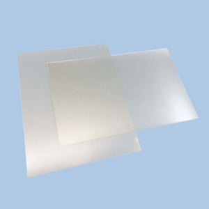 Clear acrylic sheets on blue background in overlapping arrangement