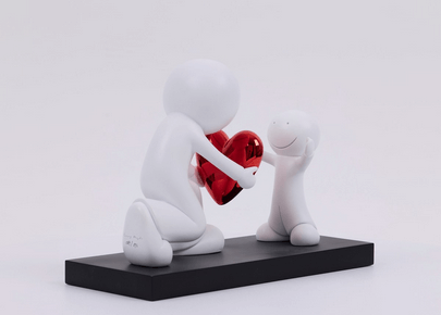 The Greatest Gift Sculpture by Doug Hyde featuring a larger figure offering a red heart to a smaller figure, symbolizing kindness.
