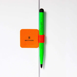 Leuchtturm1917 Pen Loop – Luminous Edition in neon colors holding a green pen on a notebook