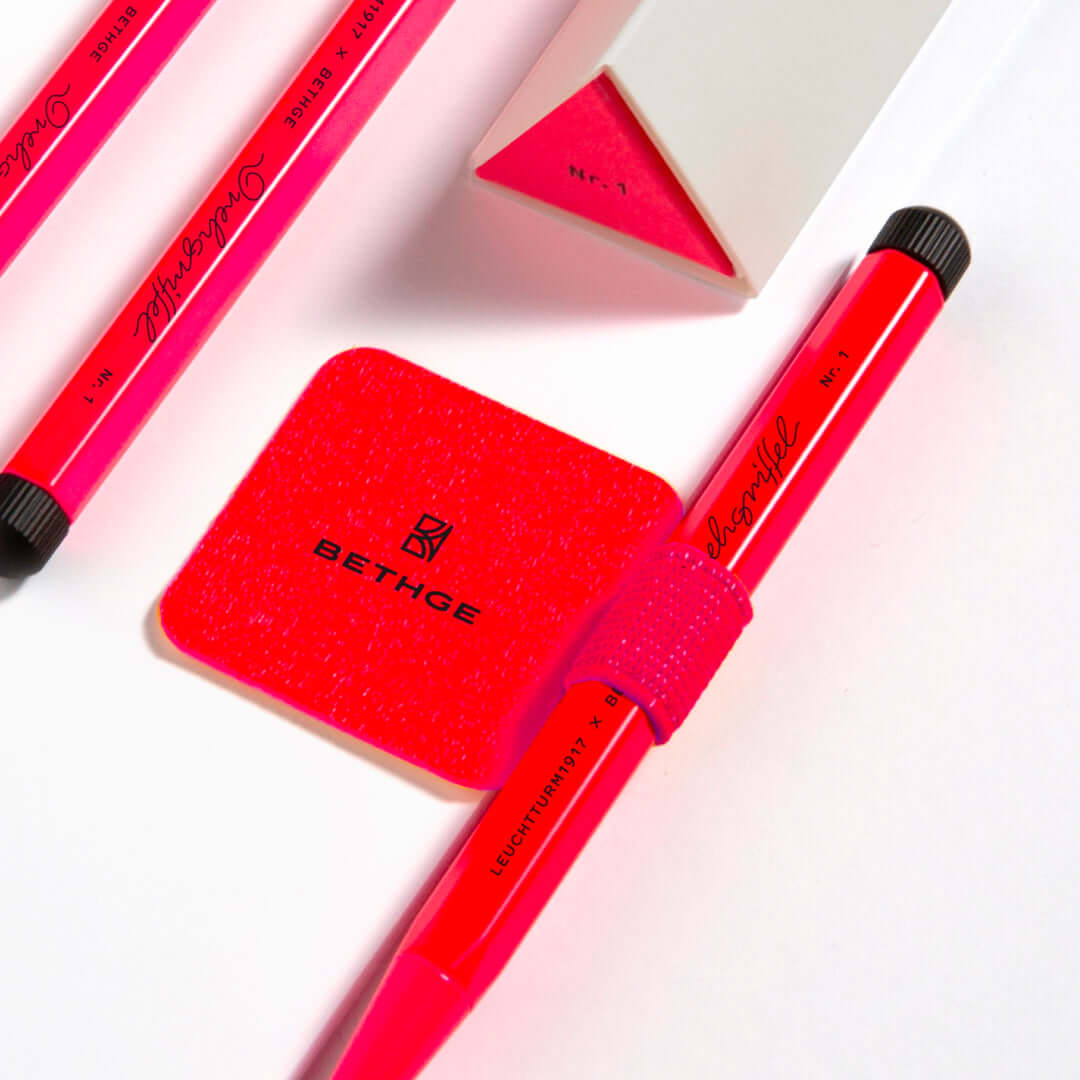Leuchtturm1917 Pen Loop – Luminous Edition in bold neon pink, featuring elastic loop and adhesive backing, perfect for notebooks.