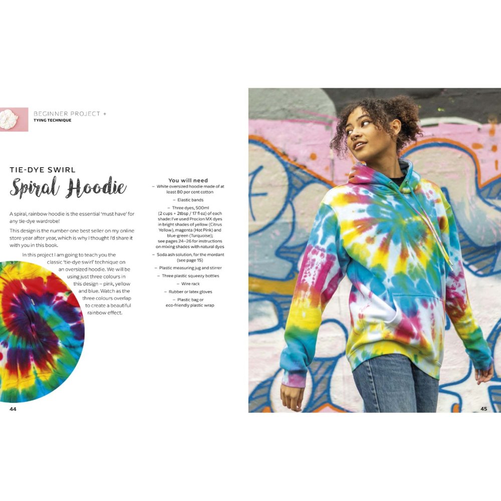 Person wearing a colorful tie-dye spiral hoodie from Modern Tie Dye – Abi Patten (Search Press) against a graffiti wall.