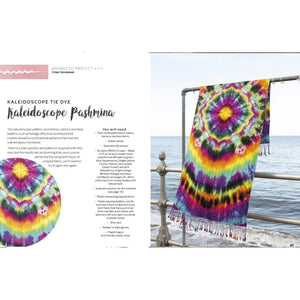 Colorful kaleidoscope tie dye pashmina from Modern Tie Dye – Abi Patten (Search Press) hanging by the sea.