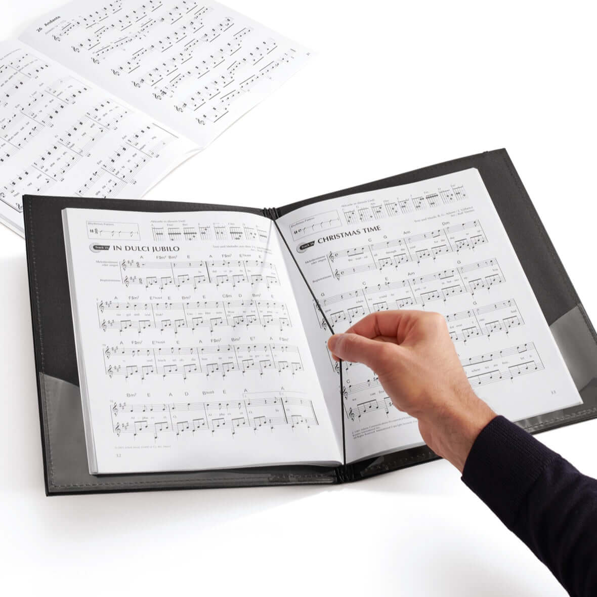 Person using Leuchtturm Music Portfolio DIN A4 – Elastic Strap & Corner Pockets to hold sheet music, showing interior features.