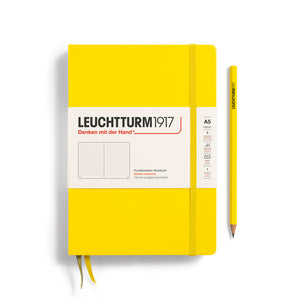Leuchtturm1917 Classic Notebook – A5 Hardcover in vibrant yellow with pencil, featuring FSC-certified paper for quality and durability.
