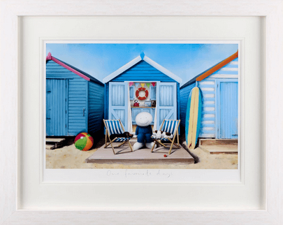 Our Favourite Days by Doug Hyde framed painting of beach huts, deck chairs, and a smiling character enjoying a sunny seaside day.