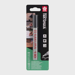 Sakura Pen-Touch 130 Black marker in packaging, showing bullet-shaped tip for versatile use on cardstock, plastic, wood, glass, and metal.