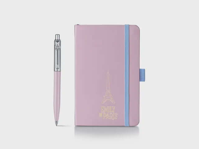 Sheaffer Emily in Paris Gift Set – Sentinel 321 Pink Ballpoint & Small Notebook with heart-shaped clip emblem.
