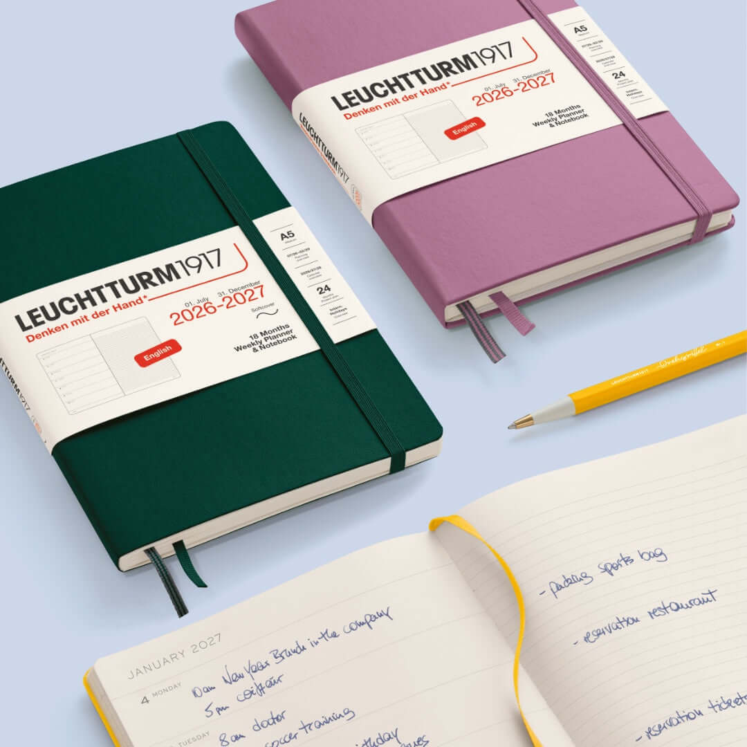 Leuchtturm1917 A5 weekly planner 2027 in green and purple with notebook page and yellow pen.