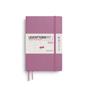 Leuchtturm Weekly Planner 2026 in B6+ paperback format with purple cover, shown with elastic closure and bookmark ribbons.