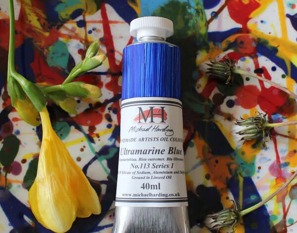 Michael Harding Professional Oil Paint 40ml Ultramarine Blue tube on colorful artistic background
