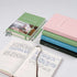 Stack of Leuchtturm1917 5 Year Memory Book – Some Lines A Day A5 in various colors with open diary showing entries